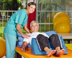 caregiver assisting patient in doing work-out