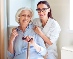 caregiver holding the shoulder of patient