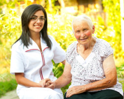 caregiver holding the hands of patient